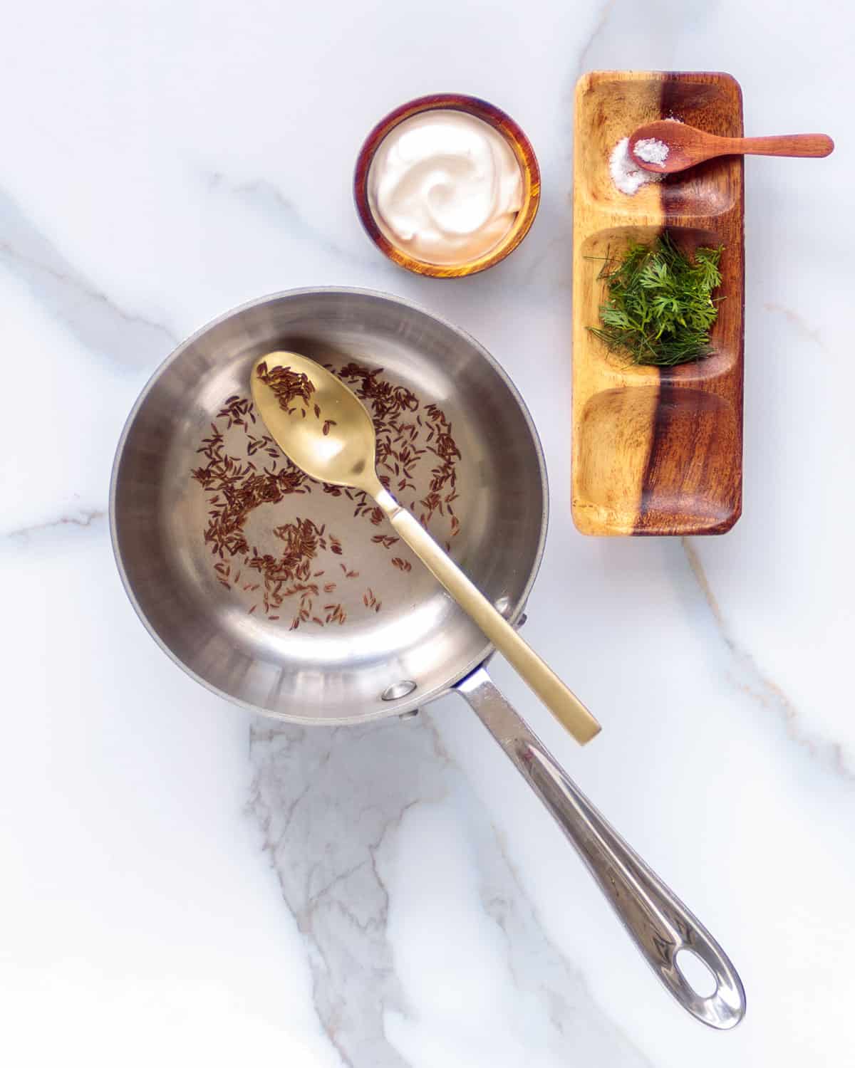 Toasting caraway seed in a dry skillet.