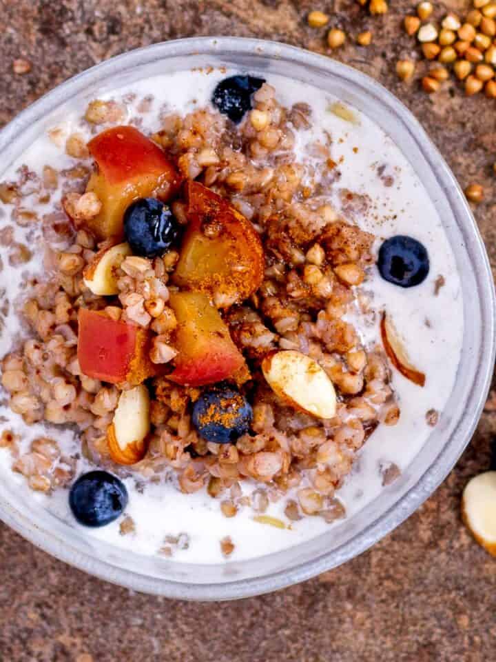 Healthy breakfast porridge with kasha grouts, fruit and nuts.