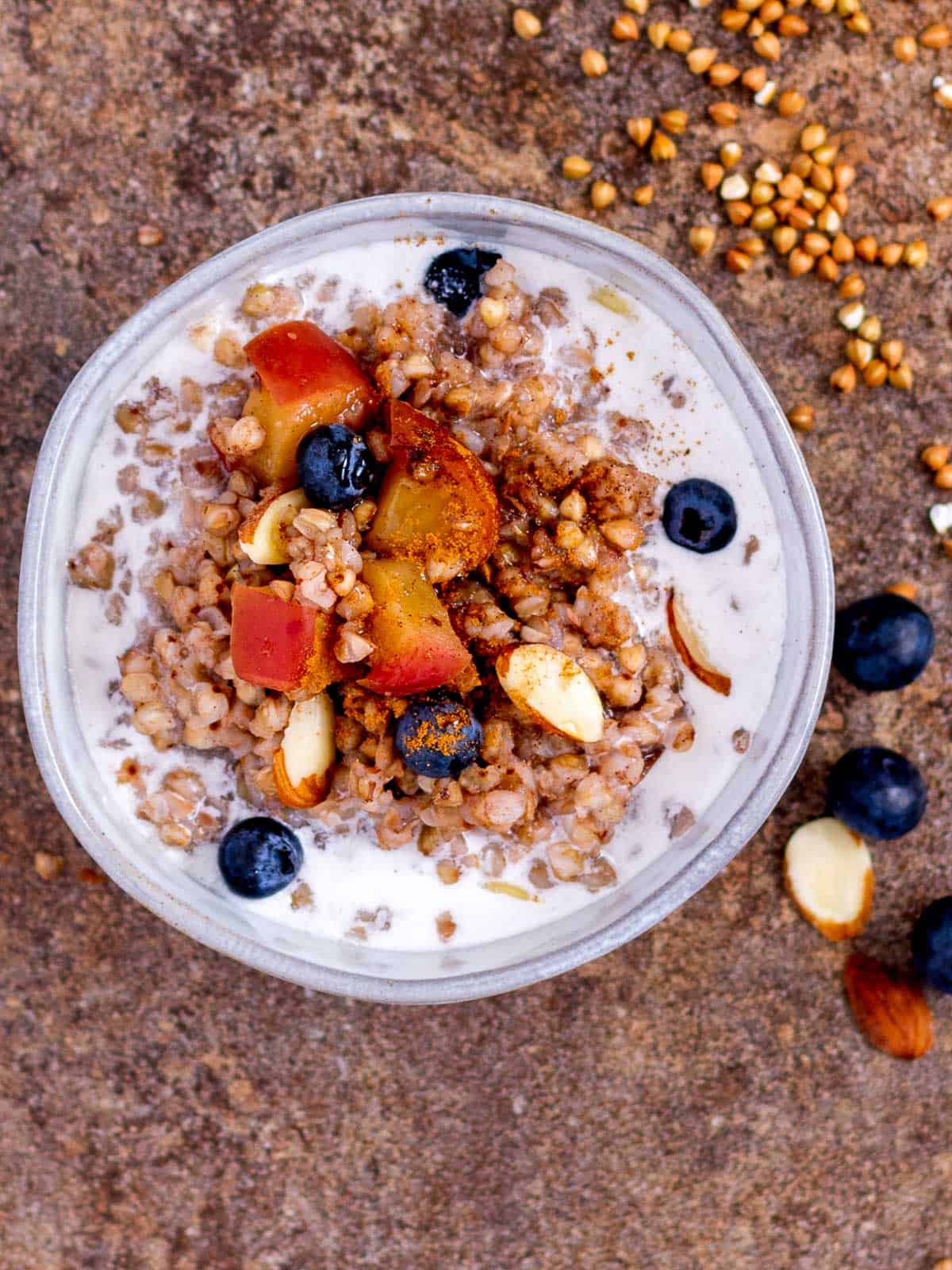 Healthy breakfast porridge made with buckwheat kasha, fruit and nut milk.