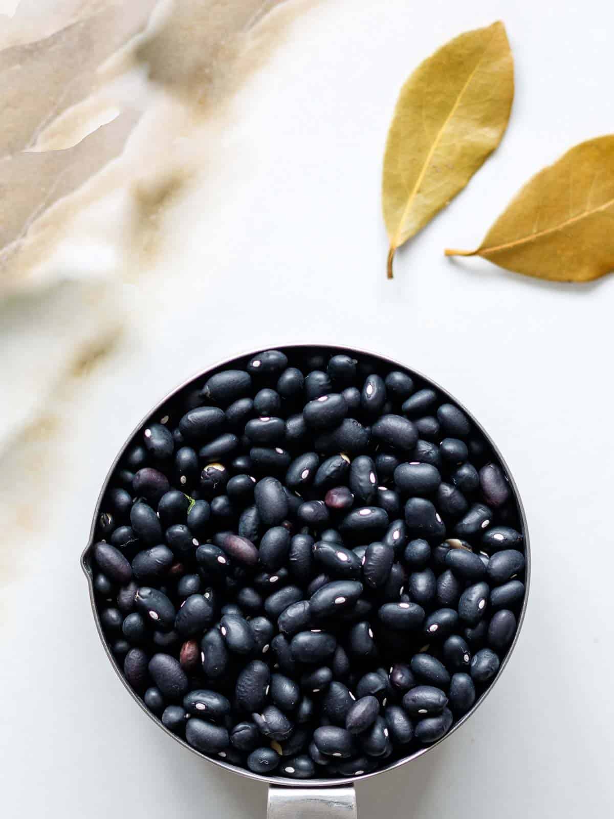 Black beans and bay leaf for tacos.