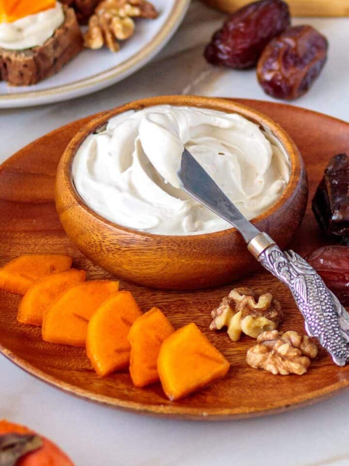 Wooden bowl of whipped vegan cream cheese.