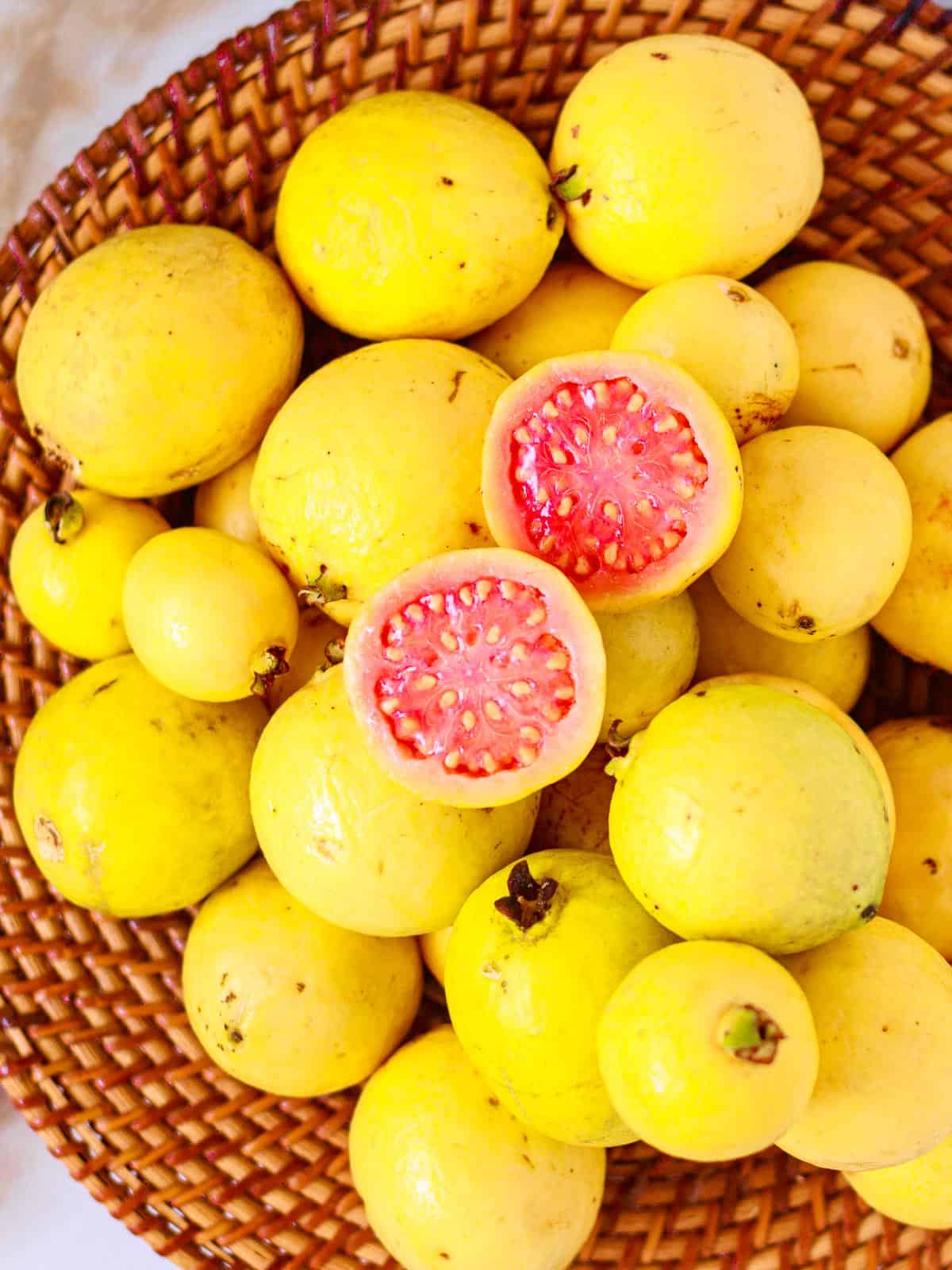 Basket of wild guavas have yellow skin and soft, juicy pink flesh with seeds.