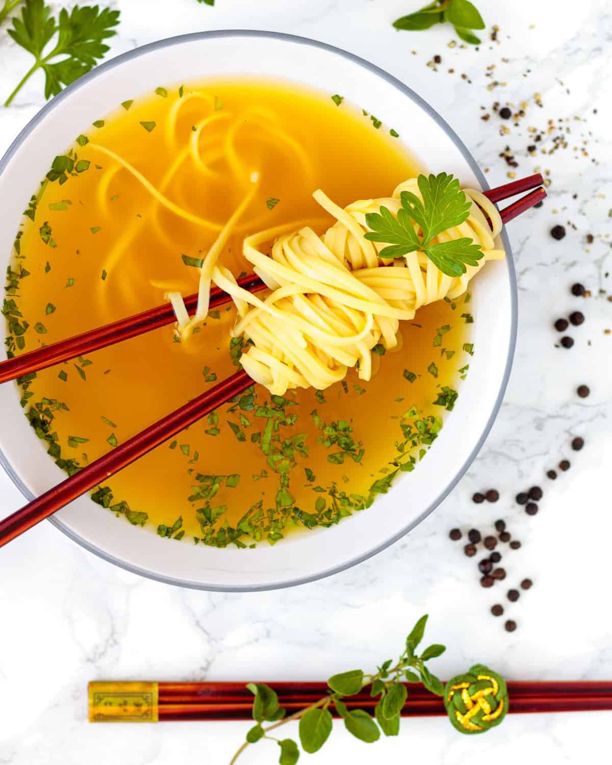 Tasty turmeric broth with noodles is an immunity boost.