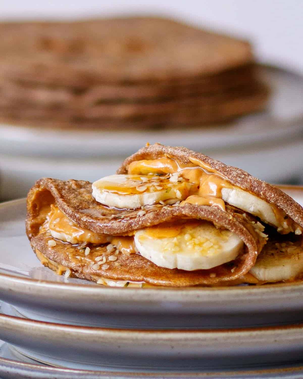 Roti filled with peanut butter and sliced banana drizzled with syrup.