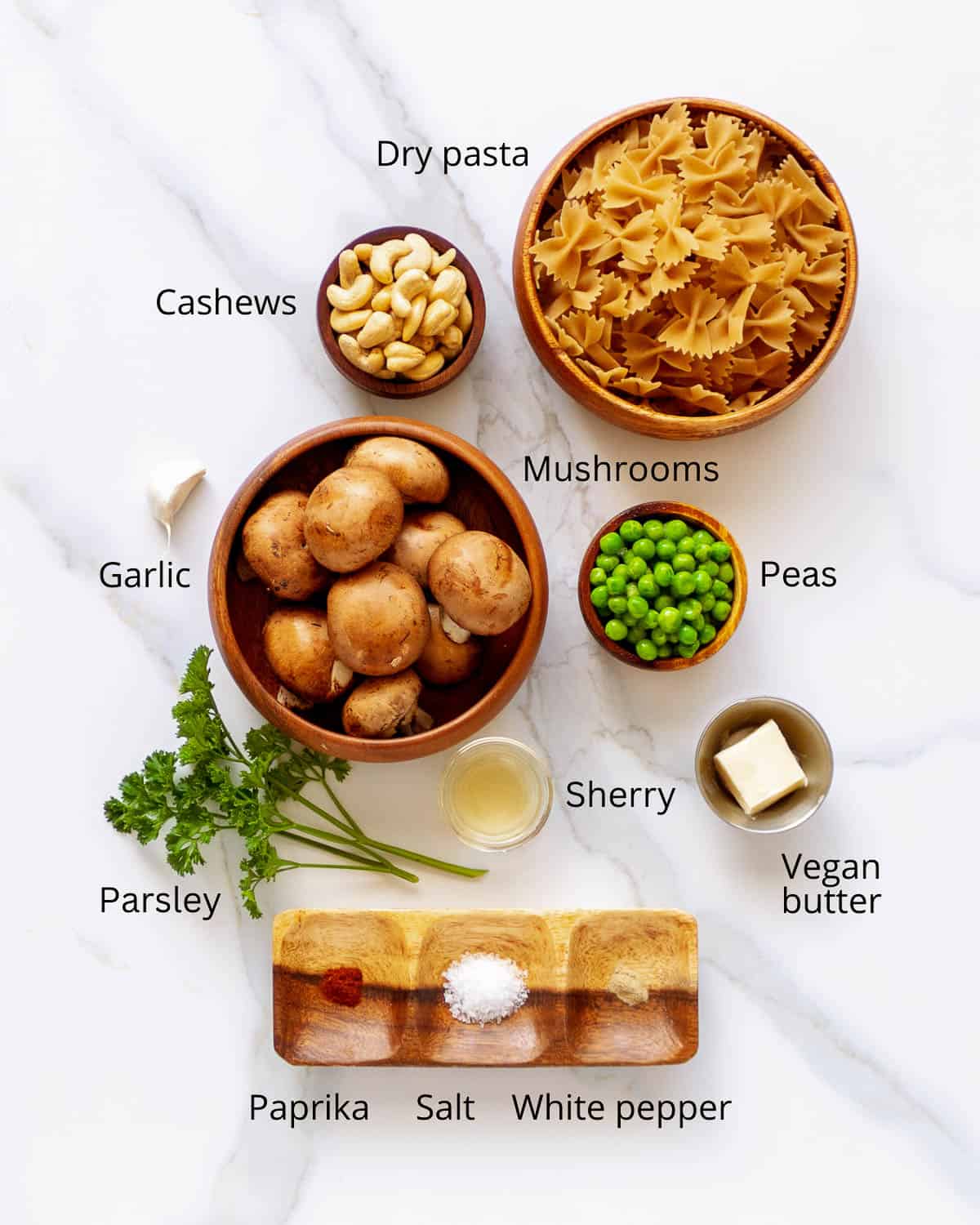 Bowtie pasta, mushrooms, cashews, peas, garlic and parsley.