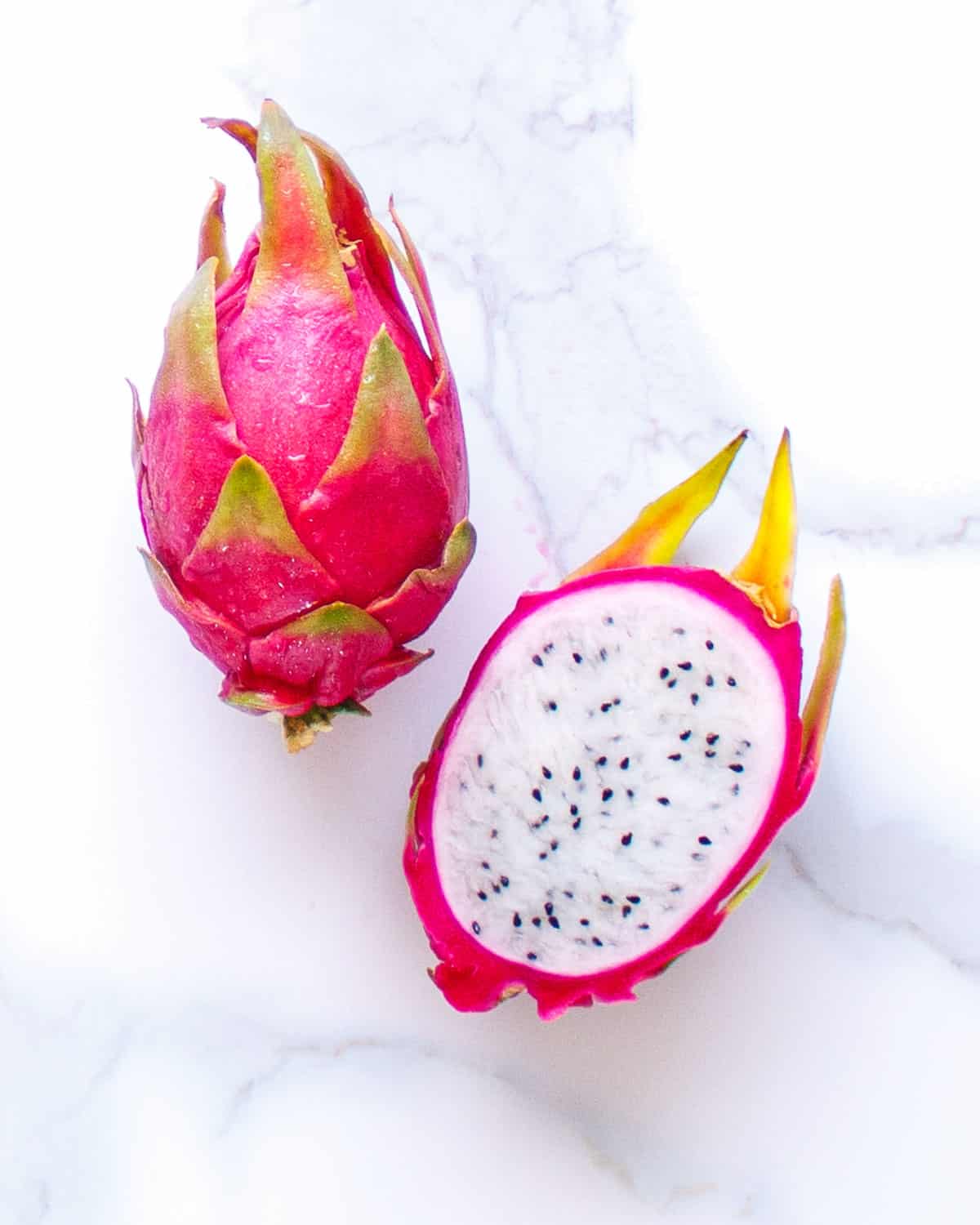 Hylocereus undatus tropical fruit cut in half.