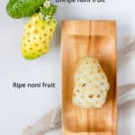 Ripe and unripe noni fruits displayed together.
