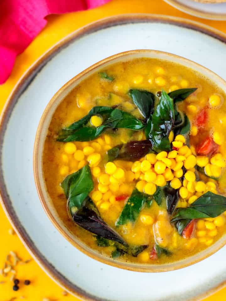Bowl of masala spiced palak dal with vegetables.