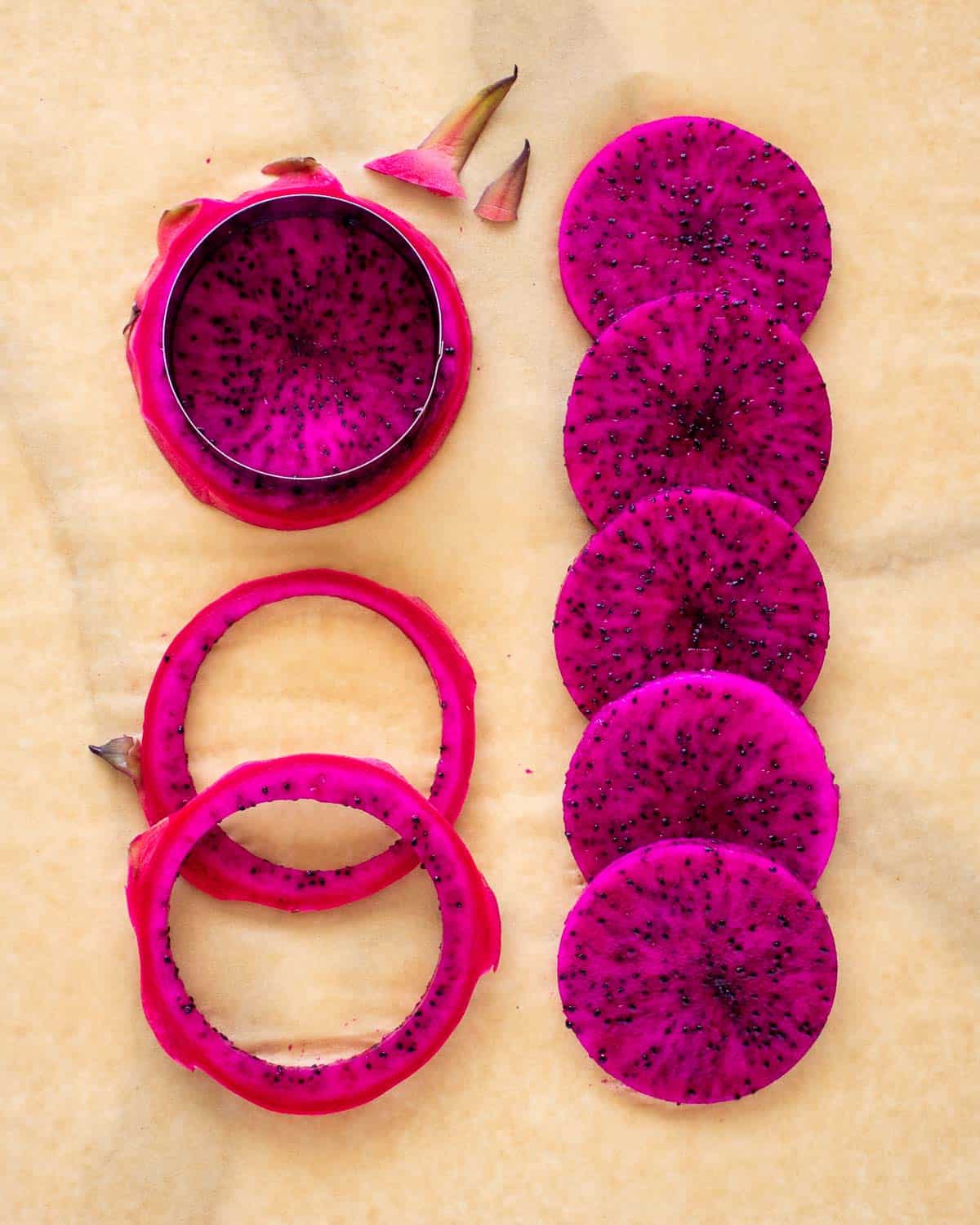 Slices of vivid purple pitaya made with a round cutter.