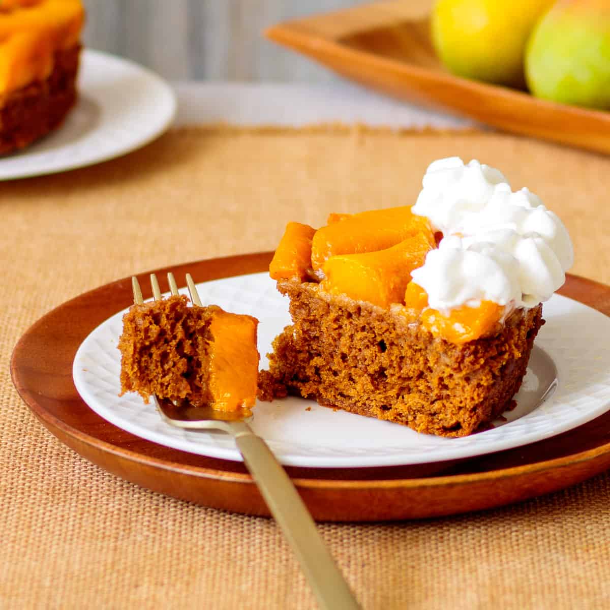 Slice of gingerbread spiced cake baked with fresh mango topping.