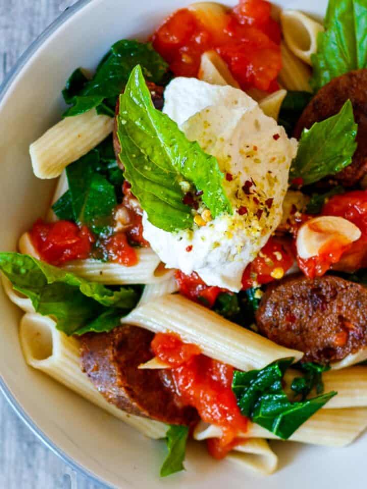 Loaded penne pasta with vegan sausage and homemade ricotta.