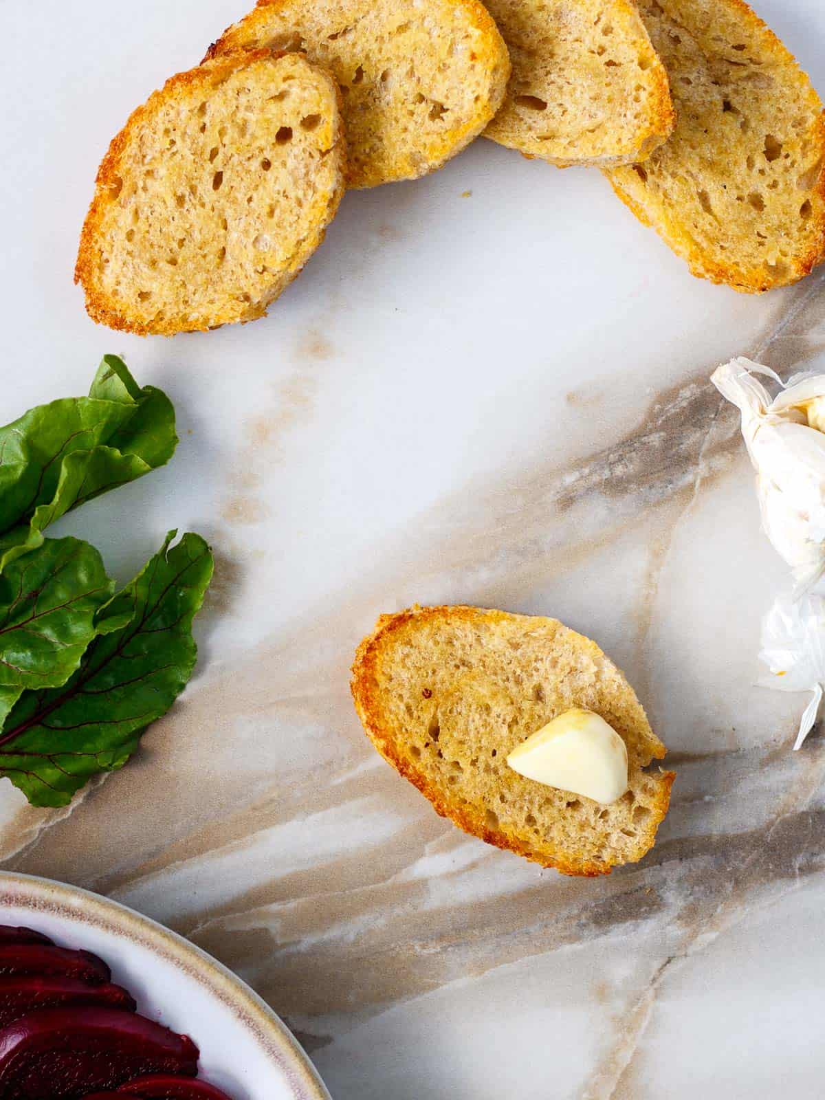 Rub toasted crostini with garlic clove.