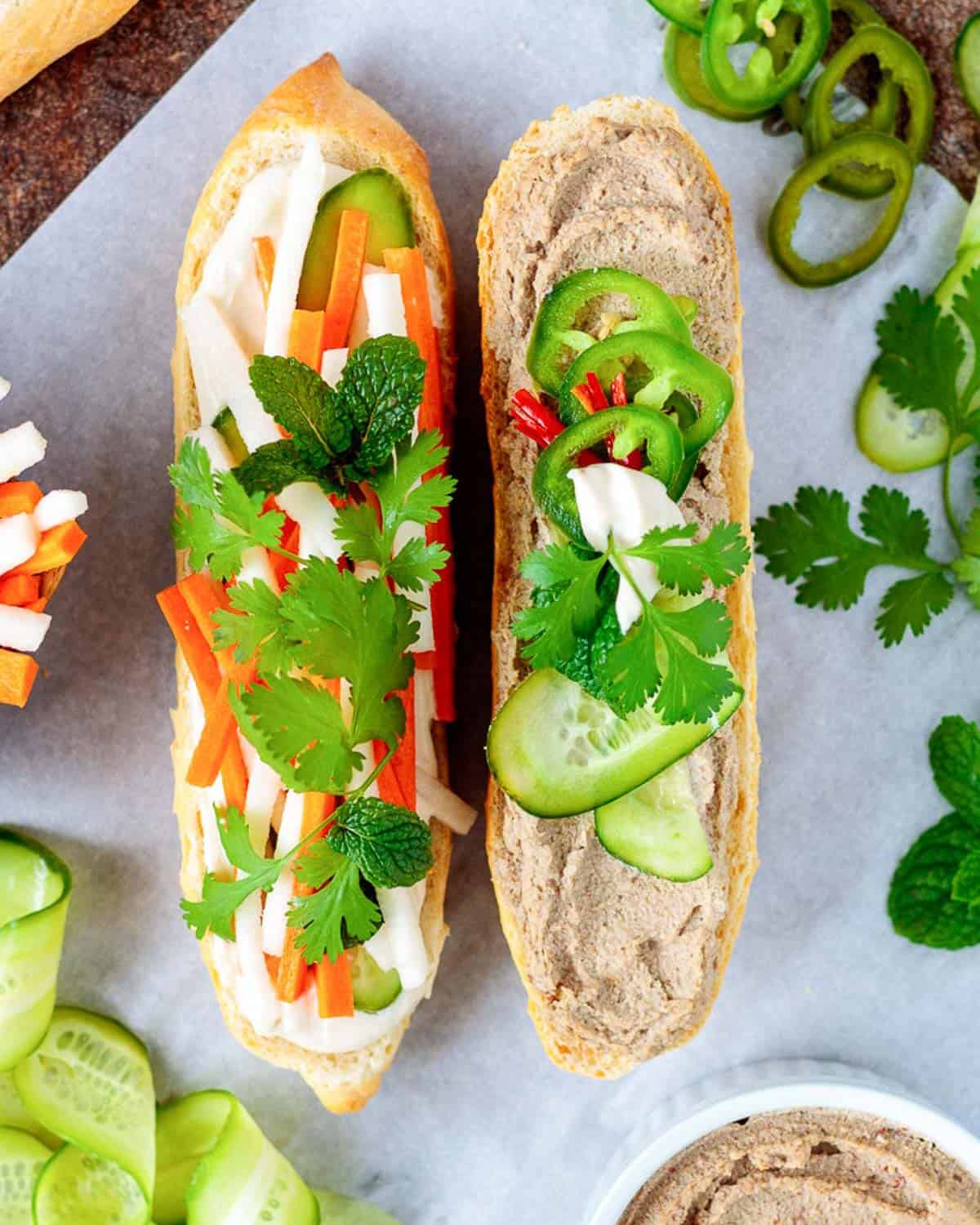 Pate spread on a Vietnamese-style sandwich with pickled carrots and herbs.