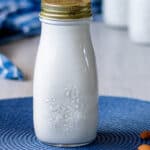 Bottle of pristine, white homemade nut milk.