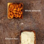 Whole almonds and almond flour on a brown tile.