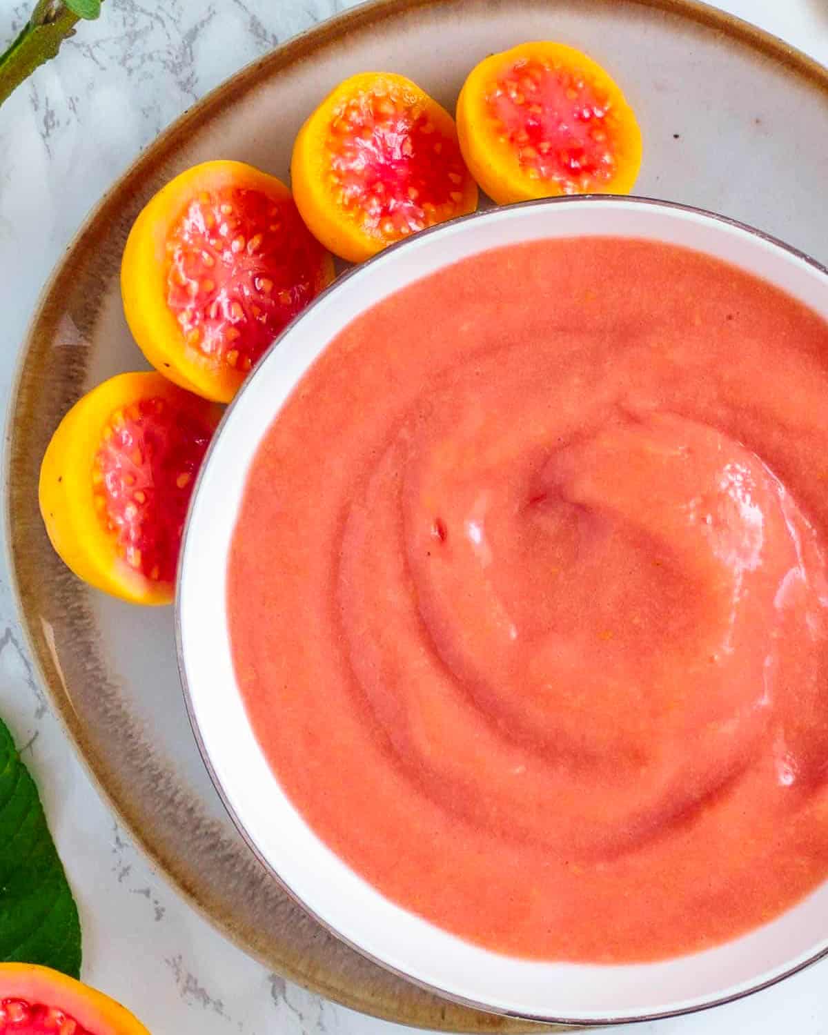 Finished bowl of pink guava puree is recipe ready.