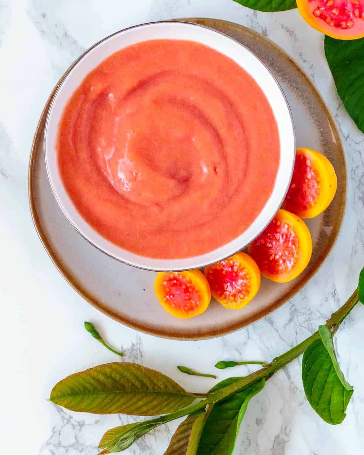 Bowl of guava puree made from fresh fruit.