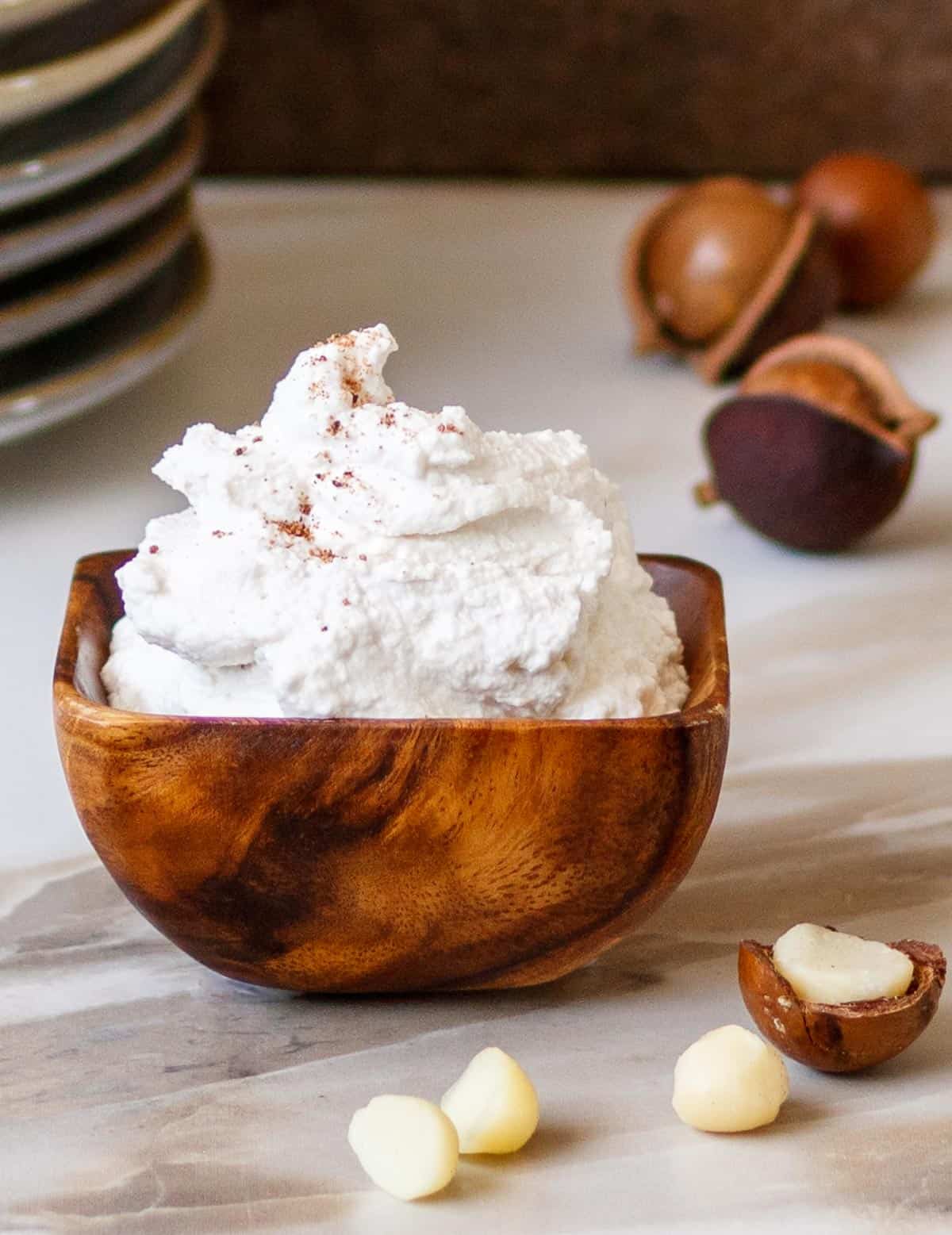 Small wooden bowl with ricotta cheese substitute.