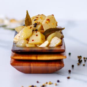 Wooden dish with marinated artichoke heart substitute.