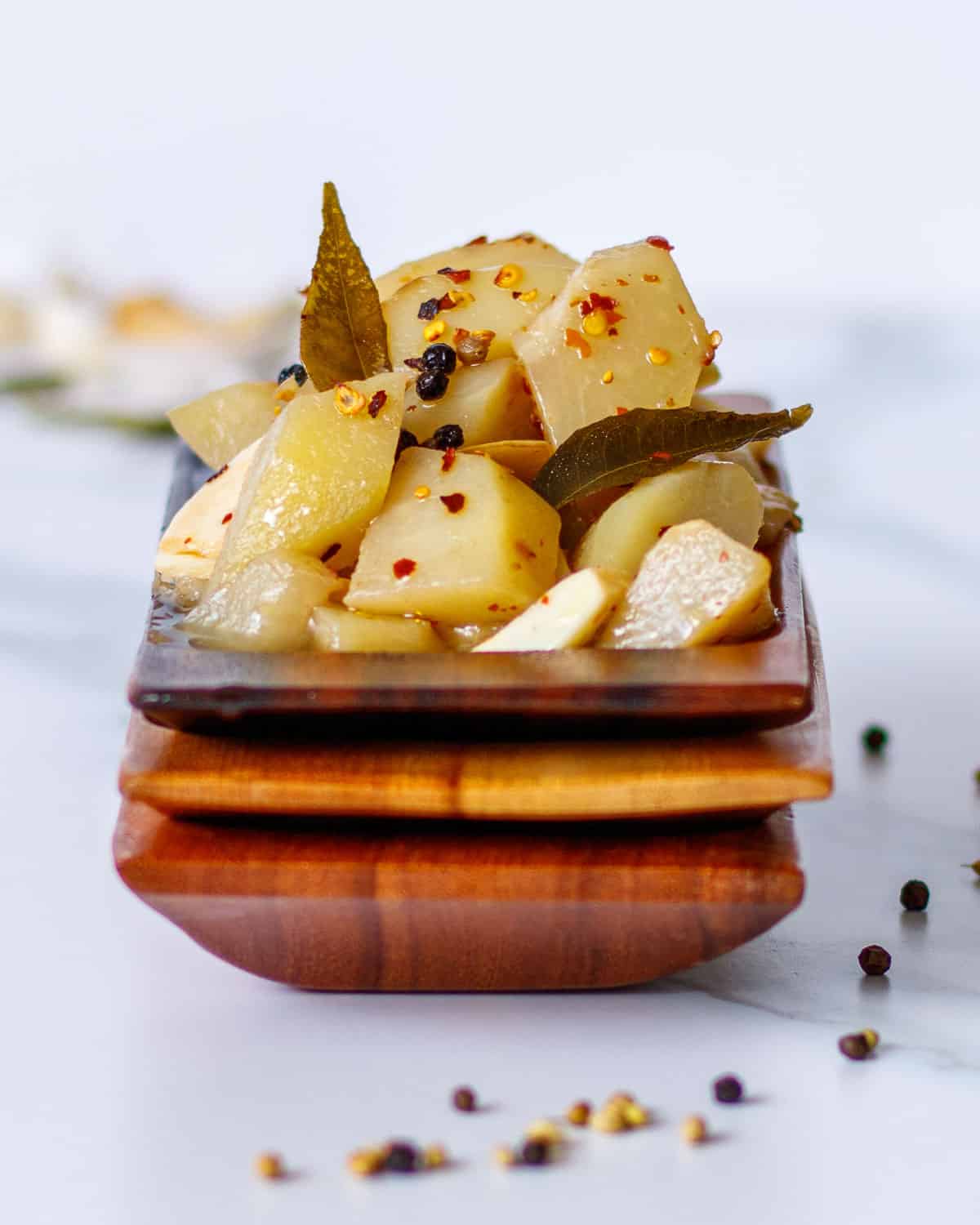 Wooden dish with marinated artichoke heart substitute.