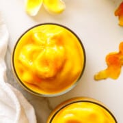Turmeric smoothie sprinkled with turmeric powder.
