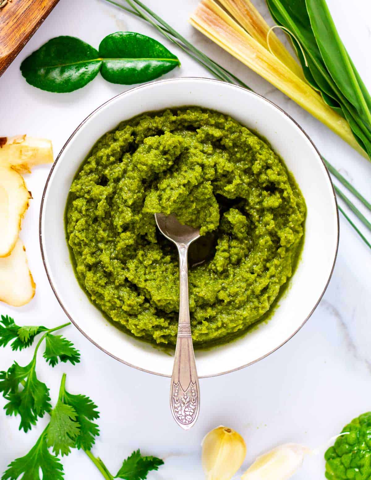 Bowl of vivid green curry paste.