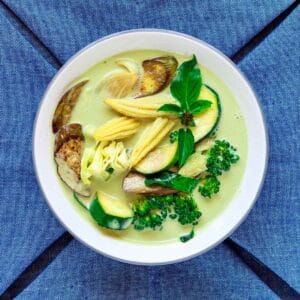 Bowl of Thai veggie curry in green coconut sauce.