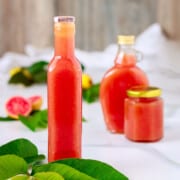 Jars of pink guava syrup made from scratch.