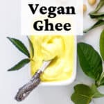 Tub of semi-solid vegan ghee with curry and guava leaves.